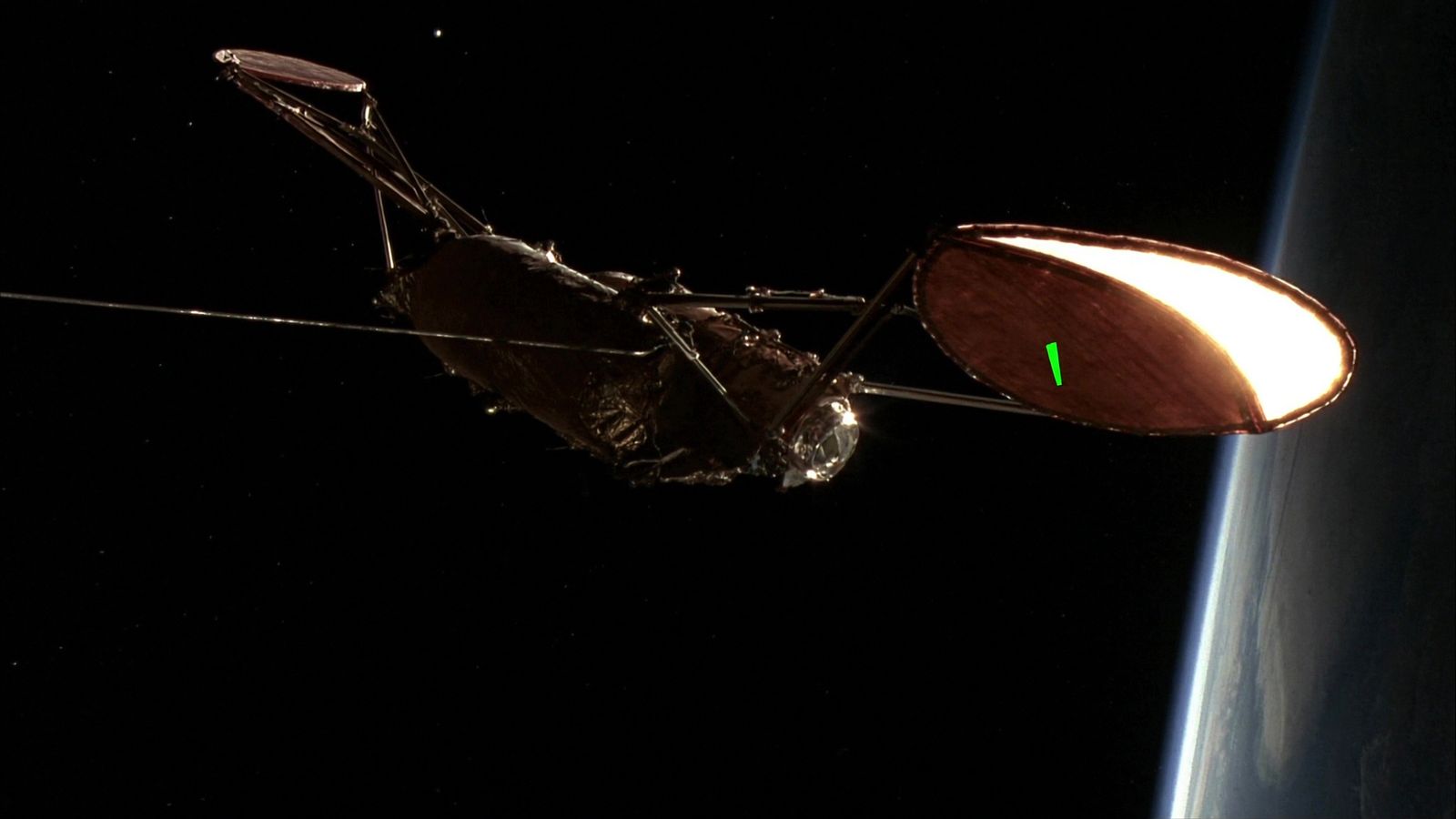 A geostationary communications satellite in shadow above a lit Earth limb, a single chartreuse marker on the solar array
