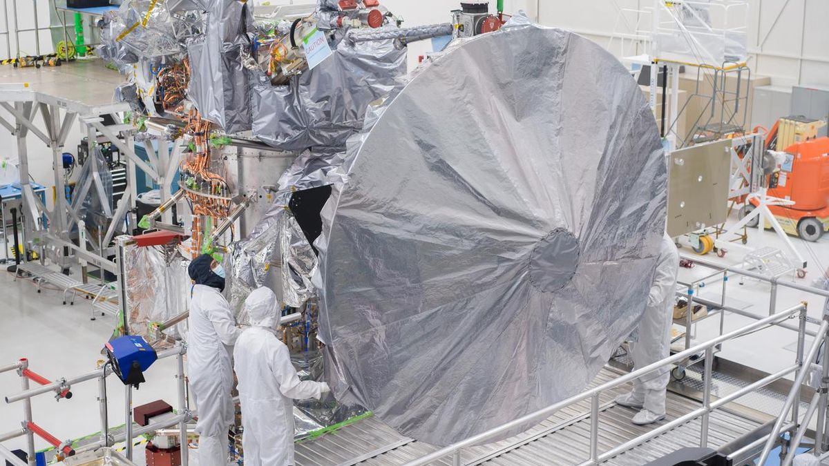 Large high-gain dish antenna installed on a spacecraft in a clean room