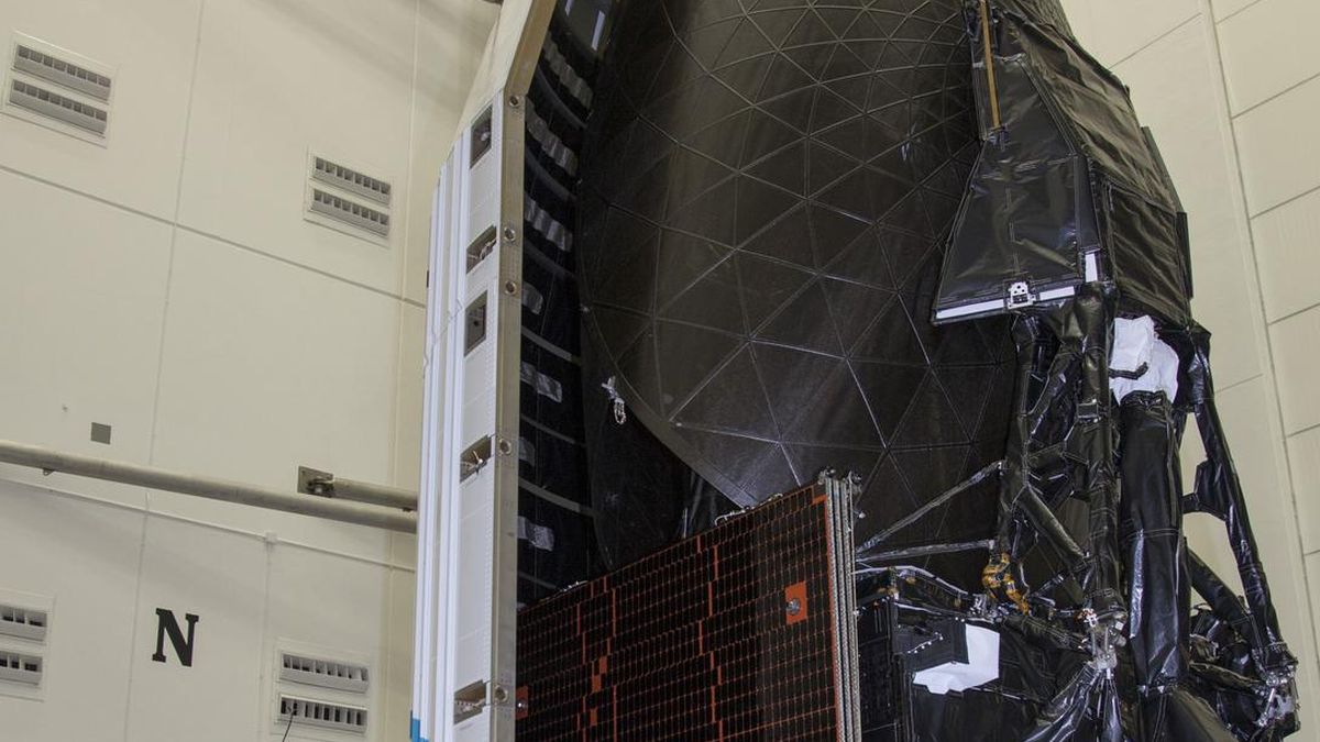 TDRS-L communications satellite beside its launch fairing before encapsulation